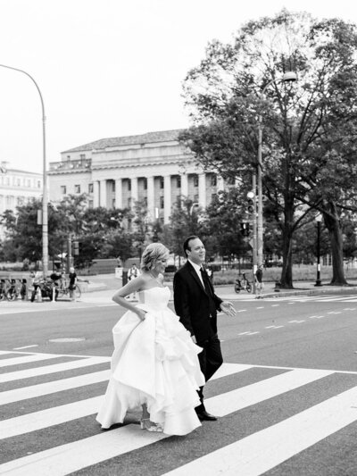 Bride and groom walk down the busy DC streets