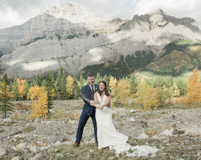 A couple smiles and embraces while eloping in banff