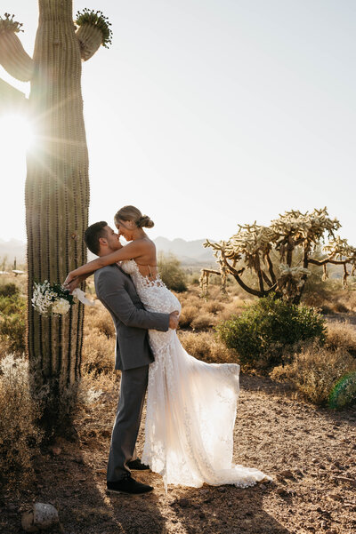 couple embraces between rocks