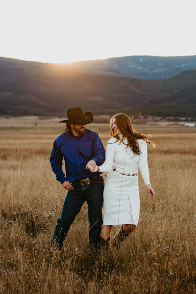 A cowboy and his lady dance as if no ones watching in the Front Range of the rocky mountains near Fort Collins, Colorado