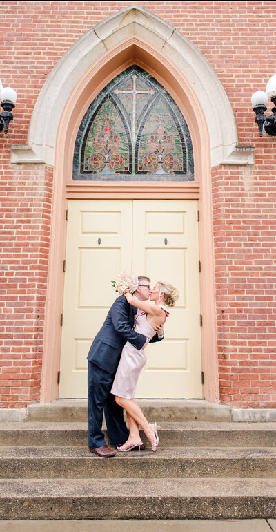 bride and groom kiss in front of Frankfort, KY The Elizabeth wedding venue doors
