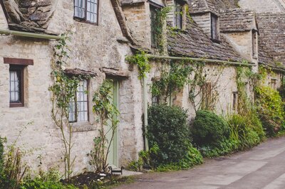 rustic stone cottage with soft green door
