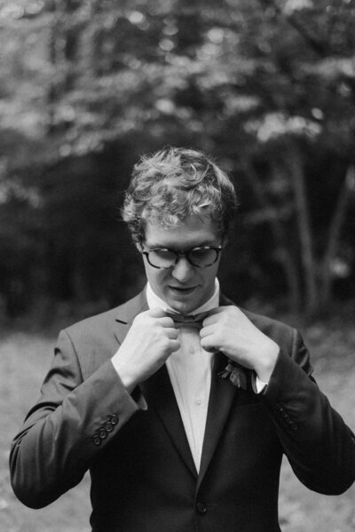 Groom adjusting his tie before his backyard wedding ceremony in Richmond, VA.