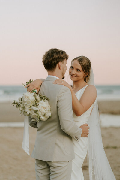 A romantic wedding photo of a beautiful couple on the beach in Coffs Harbour