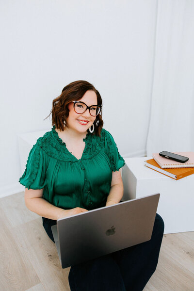 Website copywriter Sara Gillis with her hand in the air celebrating