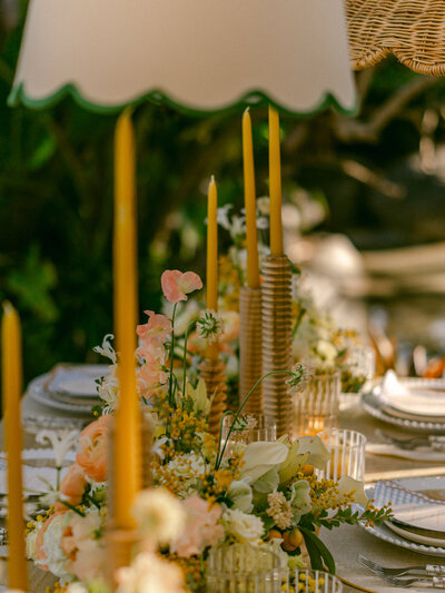 Basking in the golden glow of a citrus summer at the iconic Bahia Resort in San Diego, I had the absolute pleasure of capturing a scene of serene elegance. Tucked away in a secluded tropical garden, a charming pergola set the stage for beautifully arranged florals and meticulously styled table settings—a true mid-century retreat infused with modern whimsy. Every detail, from the vibrant citrus accents to the delicate blossoms, spoke of timeless sophistication and effortless charm. 