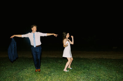 The bride and groom have a silly moment together dancing in the night by direct flash photographer Megan Lynn of My Sun and Stars Co.