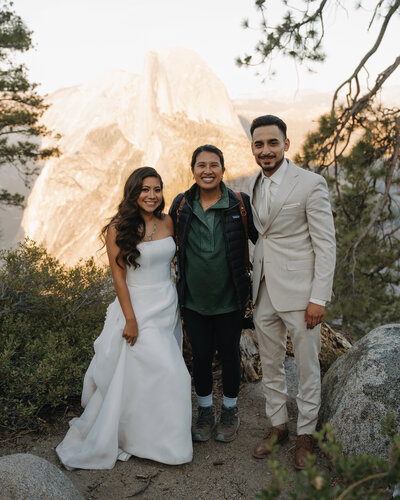 photographer posing with couple