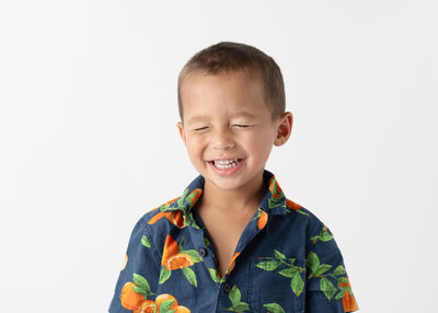 A young boy with a big smile for his school picture.