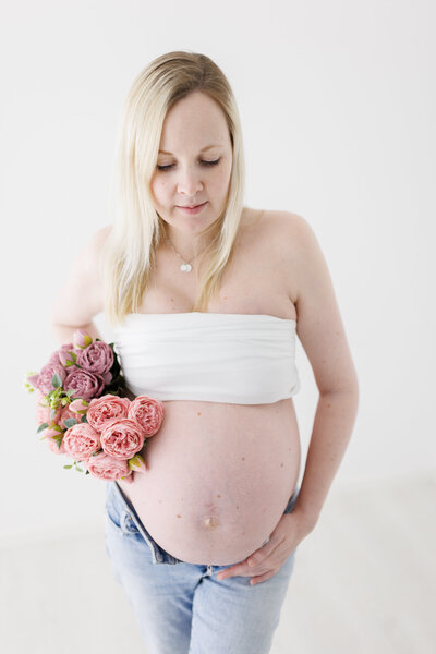 Nærbilde av baby som sover på ryggen på en grå ullfell.