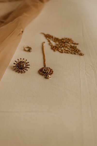 BRIDAL DETAILS LAID ON A BED TO SHOWCASEJEWLERY