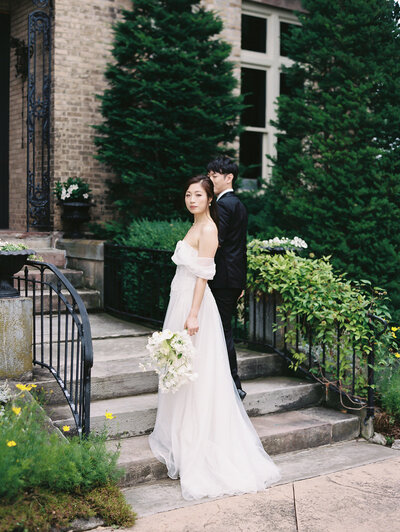 bride and groom pose in front of wedding venue in adelaide