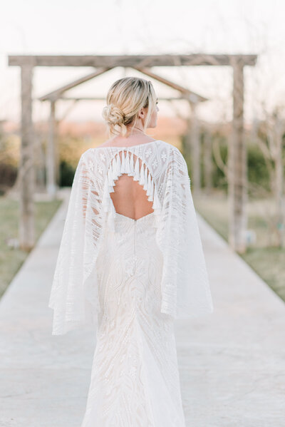 bridal portrait of the bride under a rustic arch