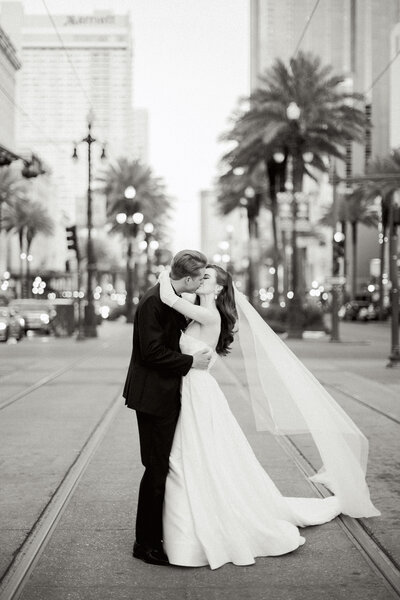Bride and groom kissing on new orleans street