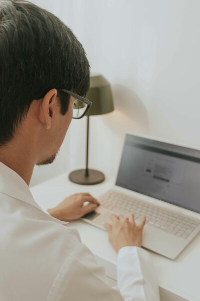 A man focused on his laptop, working intently