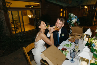 bride and groom eating pizza