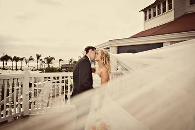Beautiful couple kissing at Hotel Del in San Diego