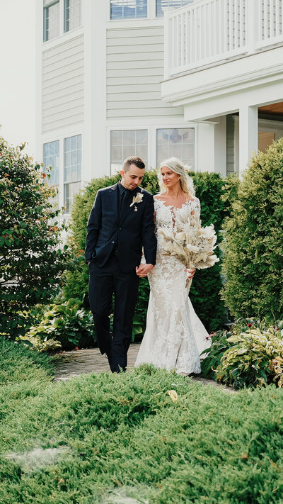 Bride and Groom in front of the farmhouse at Crispin Hill Wedding Venue