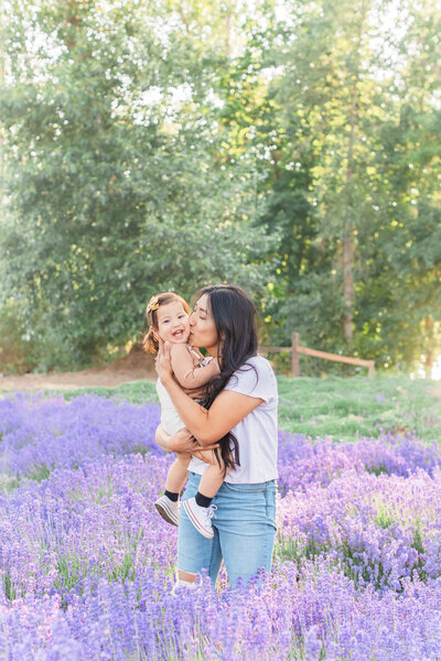 mom and baby smiling for photos in lavender field