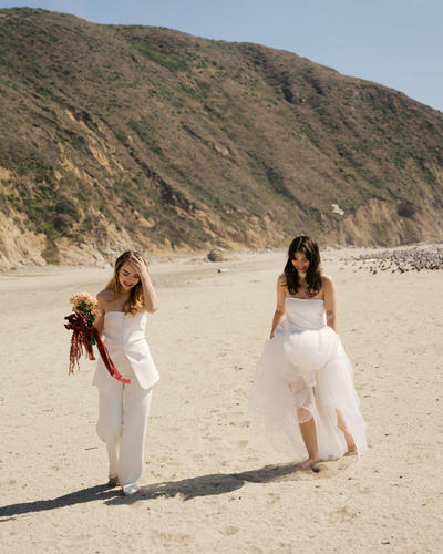 An editorial style bride smiling leaning up against a gold staircase at a hotel in Chicago, Illinois. 