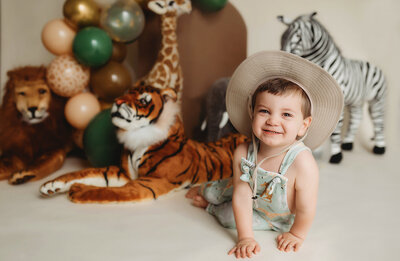 Baby celebrates first birthday with a Milestone Cake Smash Portrait Session in Asheville, NC.