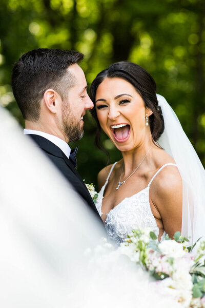 Bride and groom smiling after their wedding in Michigan.