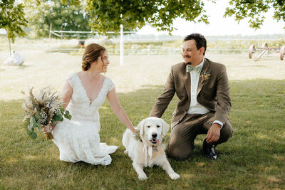 bride and groom pictures with their dog at their spring Michigan wedding