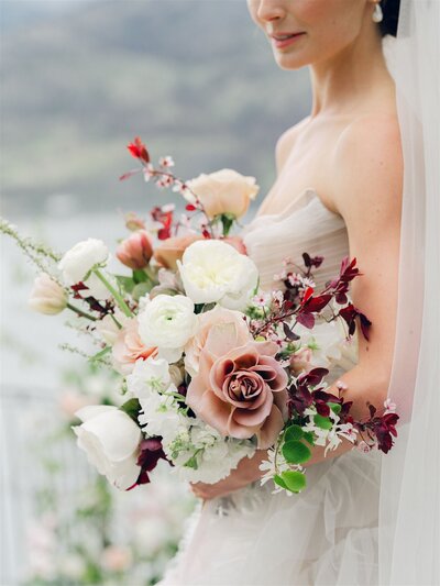 a vase with roses and weddings dresses in the background