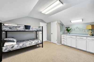 Upstairs bedroom with bunk beds in this Sleeper sofa for two with Smart TV in this 3-bedroom, 2.5 bathroom lake house with incredible view of Lake Belton located at Morgan's Point, near Rogers Park and Temple Lake Park.