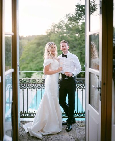 Bride and groom walking hand in hand through the gardens of a French château at sunset — Destination Wedding Photographer Portfolio.
