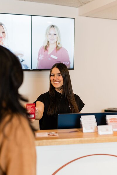 Esthetician checks out her client after a waxing treatment