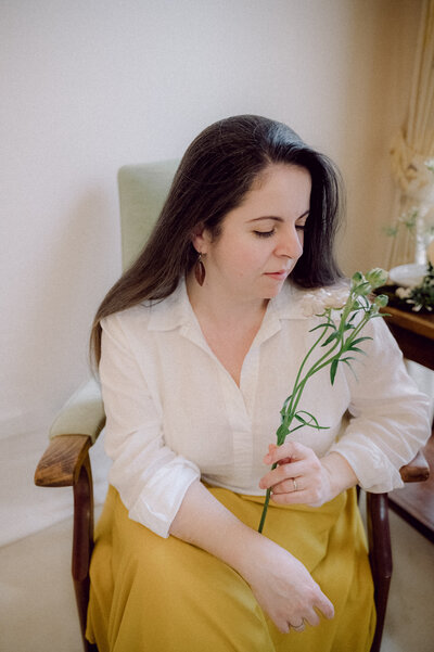 Andreea Bucur - Teastyle brand creative director and business coach holding a flower