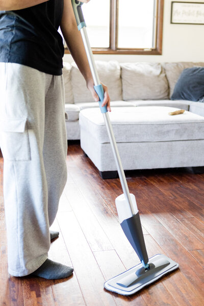 Professional cleaner mopping hardwood floors