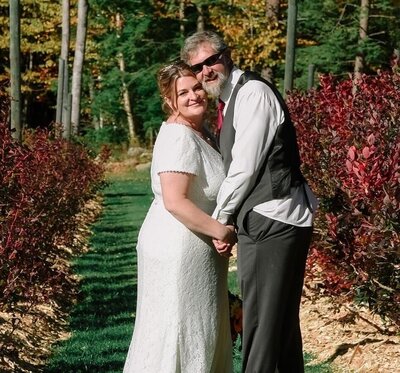 Custom website clients Kristy and Keith  smiling on wedding day at their farm