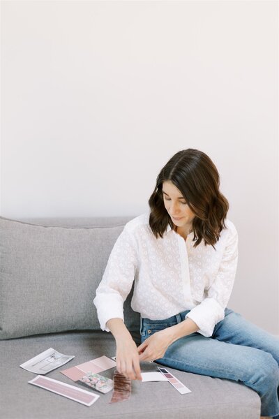 wedding designer creating wedding concept mock up sitting on couch