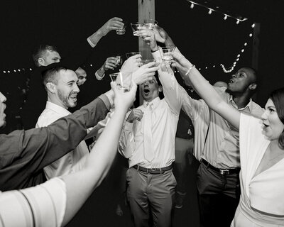 groom and groomsmen toasting at wedding reception by austin wedding photographer