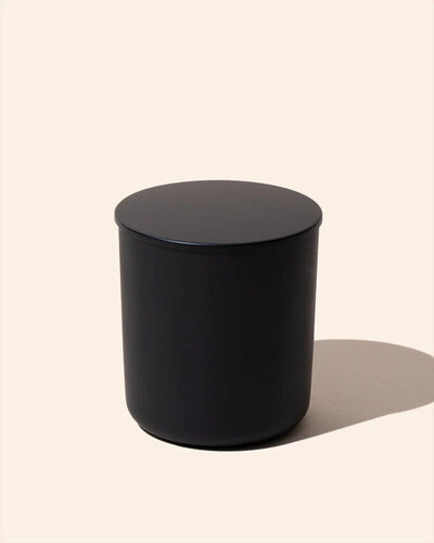 Noura Blanc Aura Candle in Black Small with lid on flat lay