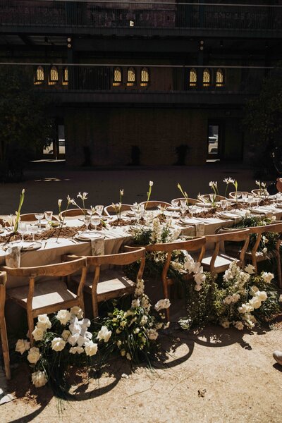 Couple kissing with happy pups in front of them