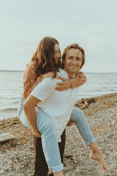 A couple sharing a moment together on a scenic Pacific Northwest beach.