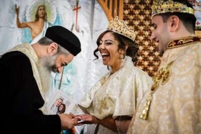 Coptic Orthodox wedding ceremony with joyful bride exchanging rings at St. Mary’s Church NJ