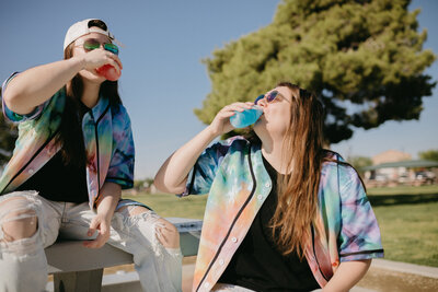 Two girls drinking juice.