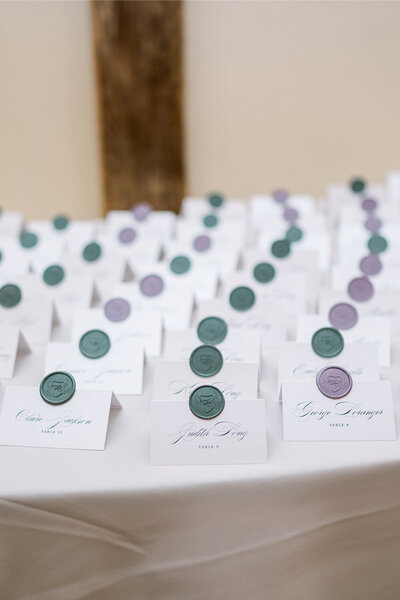 Purple and green wax seal place cards for a summer Montana wedding.