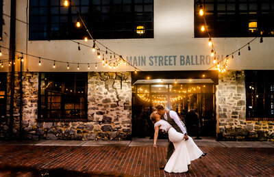 Couple dips infront of Mainstreet Ballroom, by Baltimore Wedding Photographer Kimberly Dean