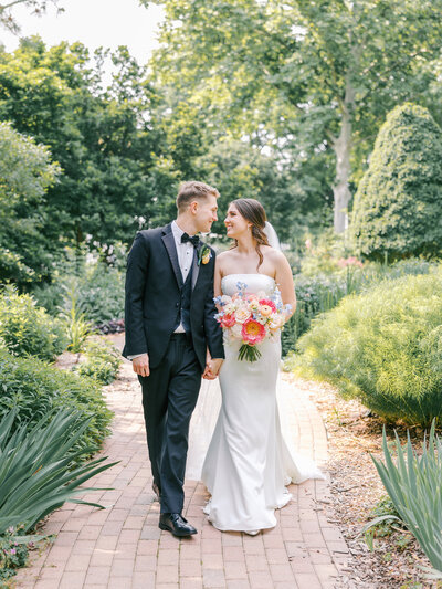 Groom lifting bride in a field in Virginia