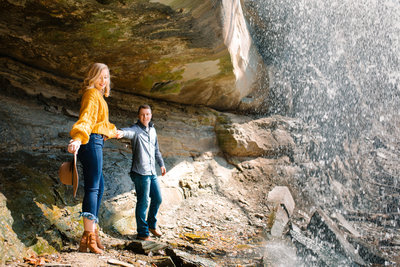 man and woman walking under rocks