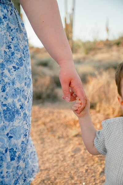 mother and son holding hands in the desert 