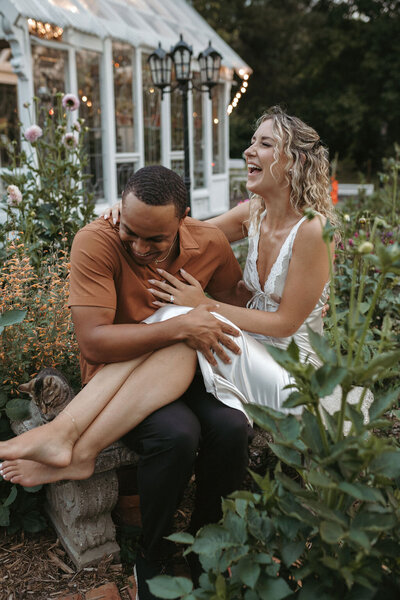 Couple posing in front of a green house during their Michigan session
