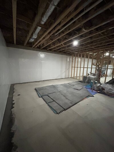 Basement waterproofing in Atlanta with a focus on installing a moisture barrier to protect the space from water intrusion.