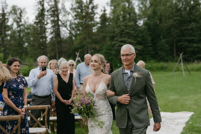 A father walking his daughter down the aisle.