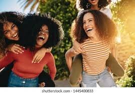 Girl on another girl's back and smiling